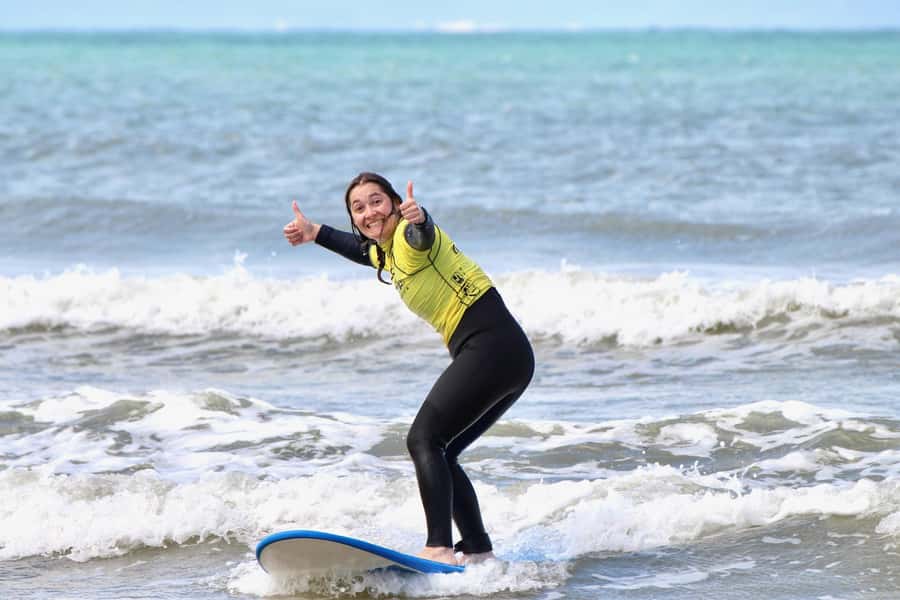 Jeffreys Bay: Learn to Surf Group Lesson - Trying to stand and ride your first wave